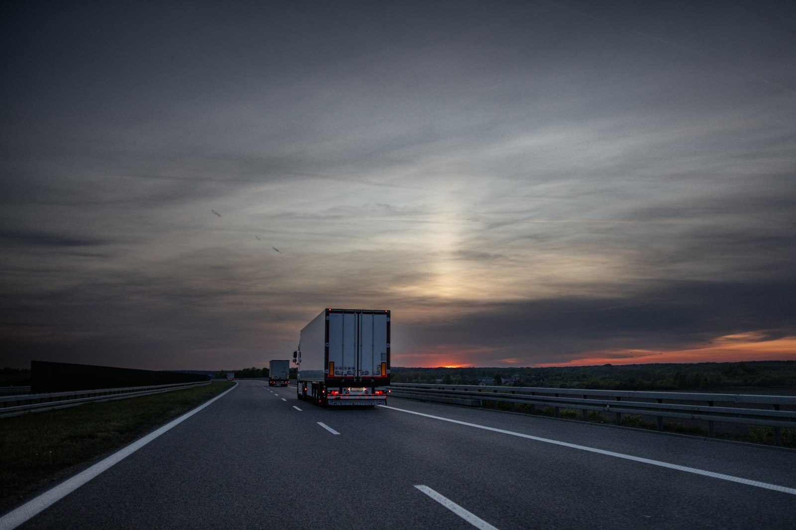 Class 8 semi truck on highway at golden-hour, side profile