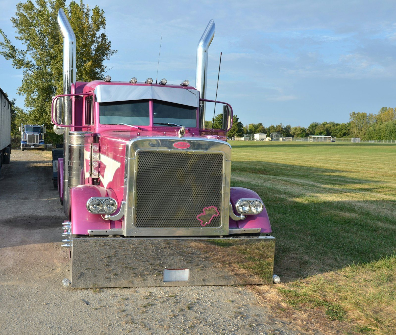 Red Class 8 semi-truck on a country road