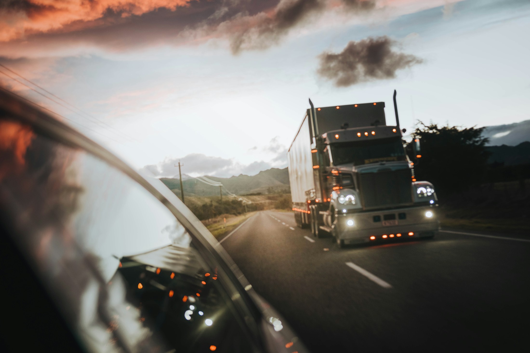 Class 8 semi truck on highway at golden-hour, side profile